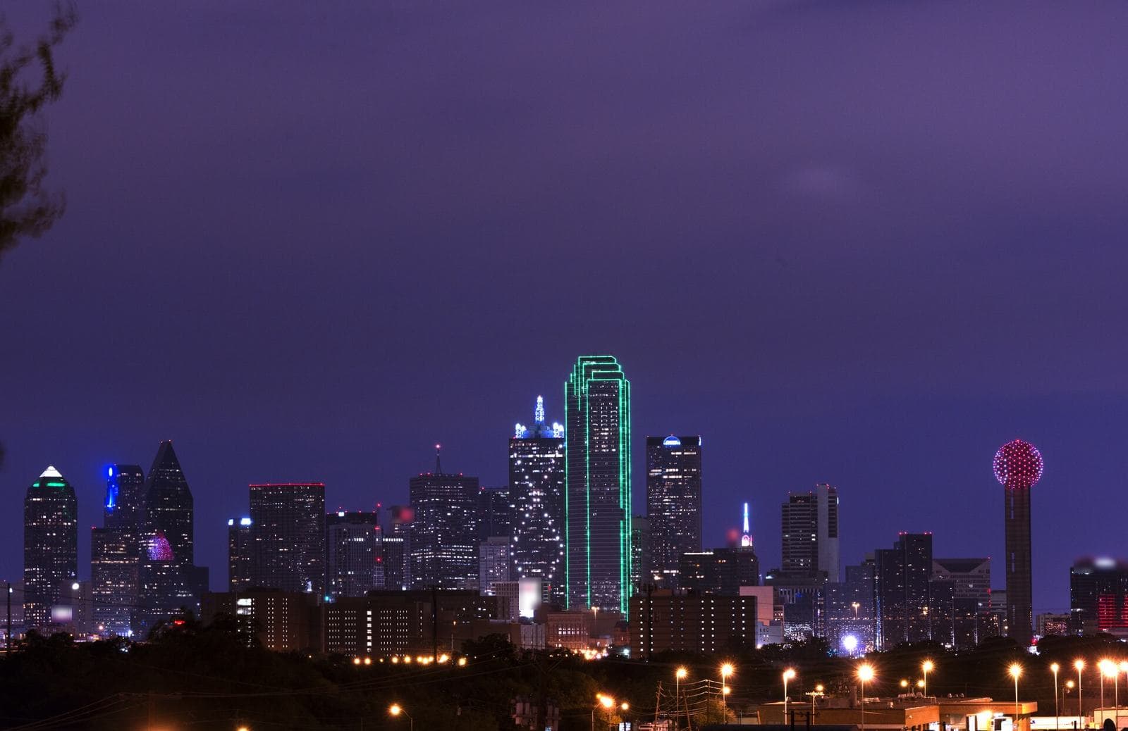 Downtown Dallas skyline at dusk with lit towers and Reunion Tower